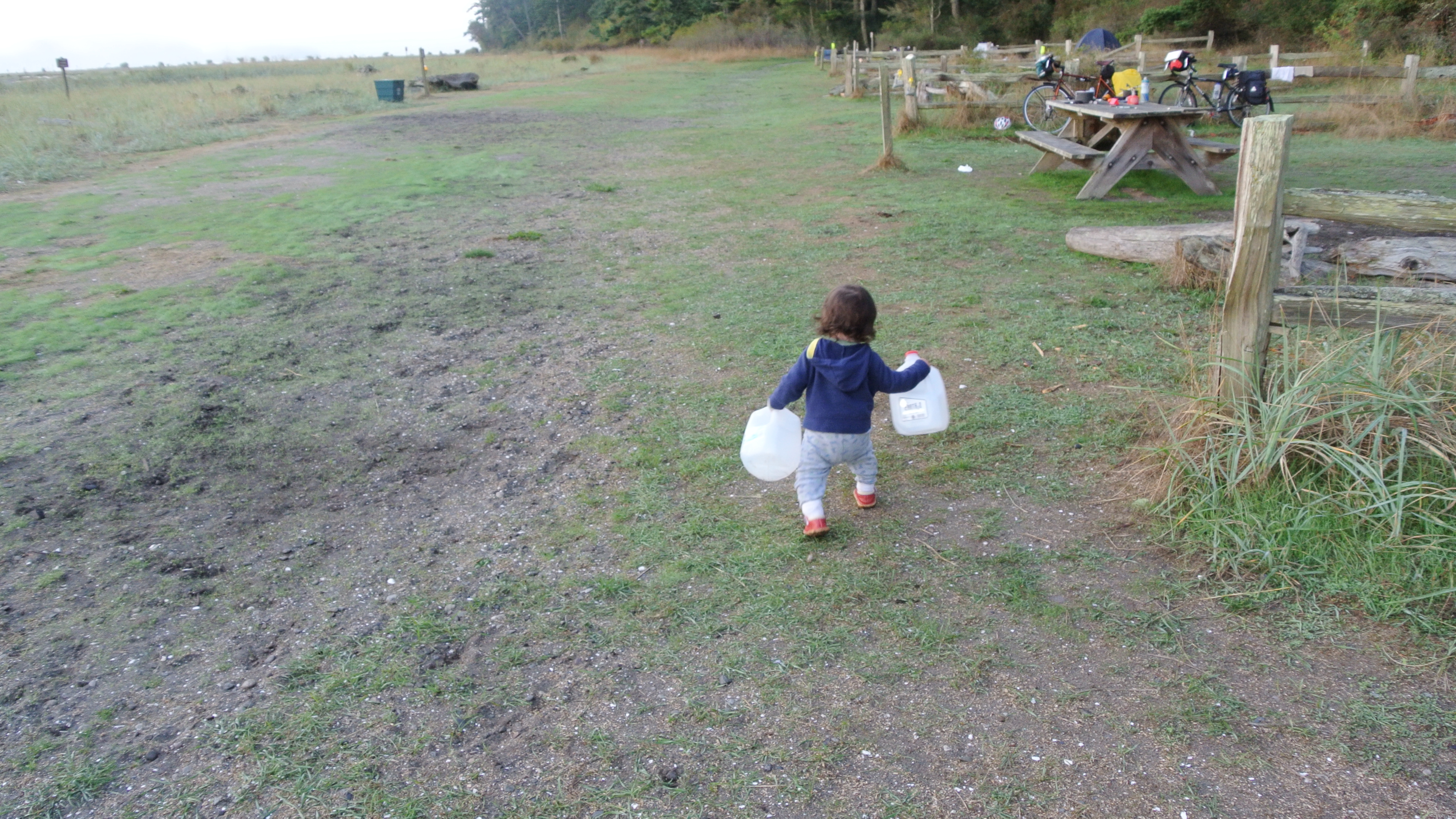 We had to carry our own water to the campsite.  Here is Polina helping to carry empty gallon containers to the well.