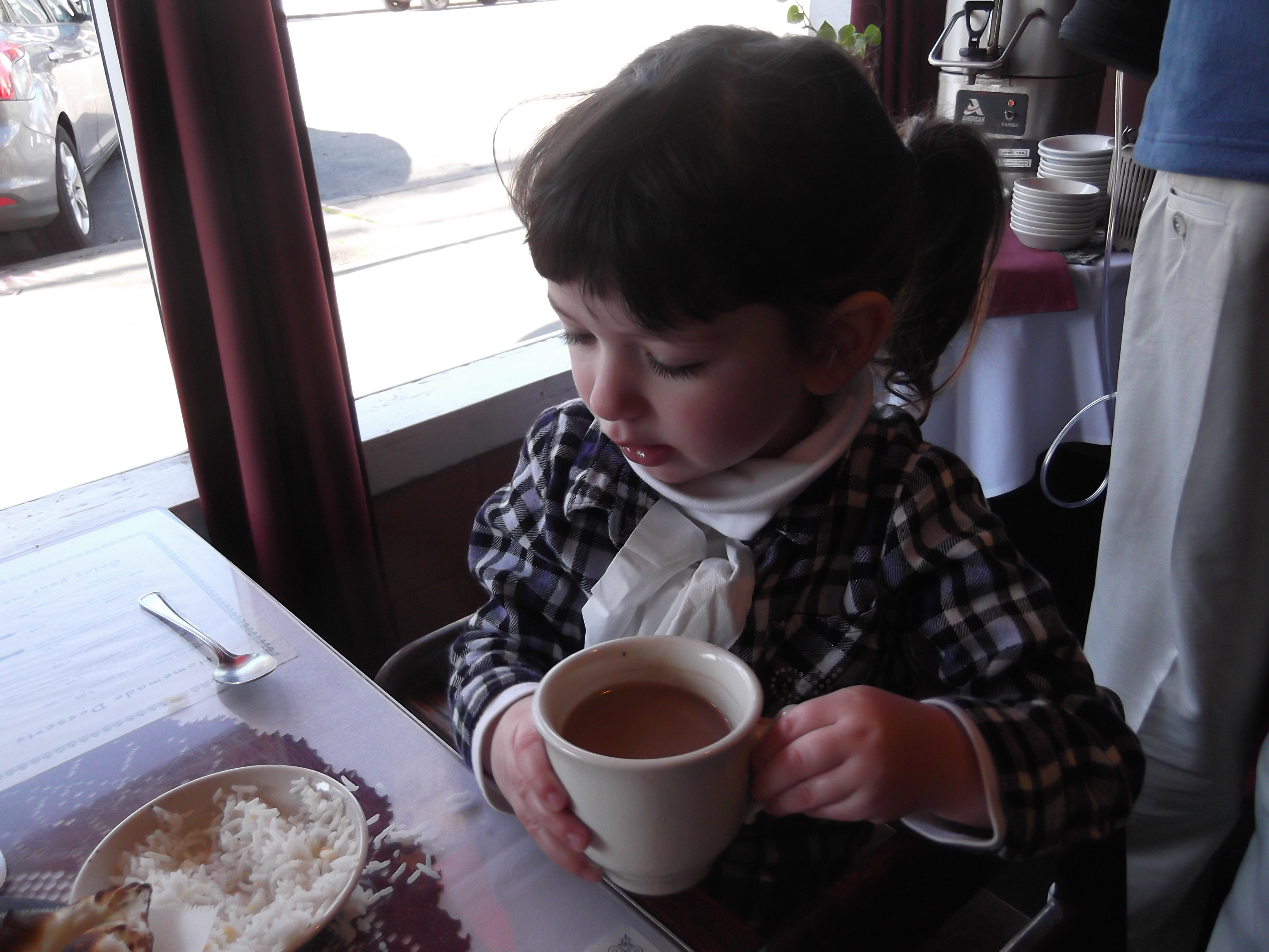 Polina at the Indian buffet drinking chai.