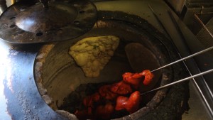 Making naan and tandoori chicken.