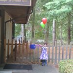 Polina swinging her lunch bag.